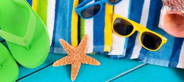 beach essentials like flip flops sunglasses towel