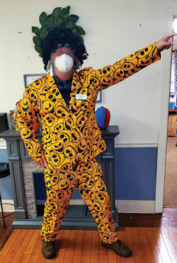 Elizabethtown staff member dressed in a suit with orange jack-o-lanterns print