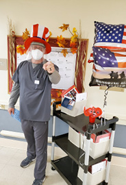 Elizabethtown Nursing and Rehab staff member with rolling cart full of Veteran's Day Cards