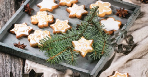 close up of star shaped sugar cookies sitting on baking sheet