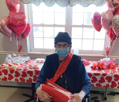 Elizabethtown resident sitting in chair in front of Valentines Table