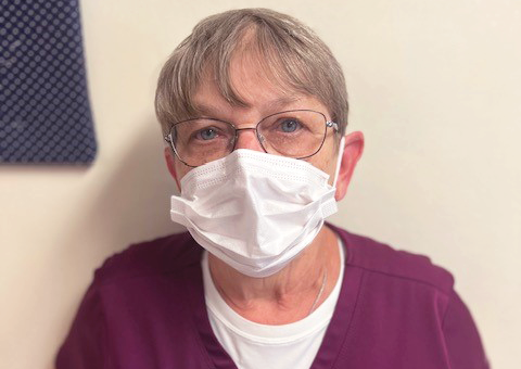 Elizabethtown Nursing and Rehab employee Bea pictured wearing covid mask