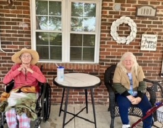two older adult women residents of Elizabethtown sitting on front porch together