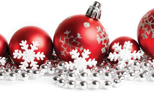 close up of red round christmas tree ornaments and snowflakes