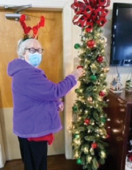 Elizabethtown resident putting up ornaments on the Christmas Tree