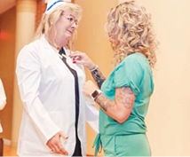Elizabethtown CNA Shelly Ross receiving a pin on her coat