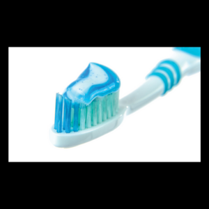 Image of a white toothbrush with blue and green markings and blue toothpaste on the brush